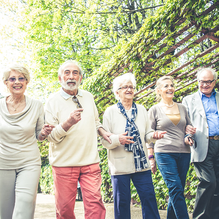 A group of five older people walking together