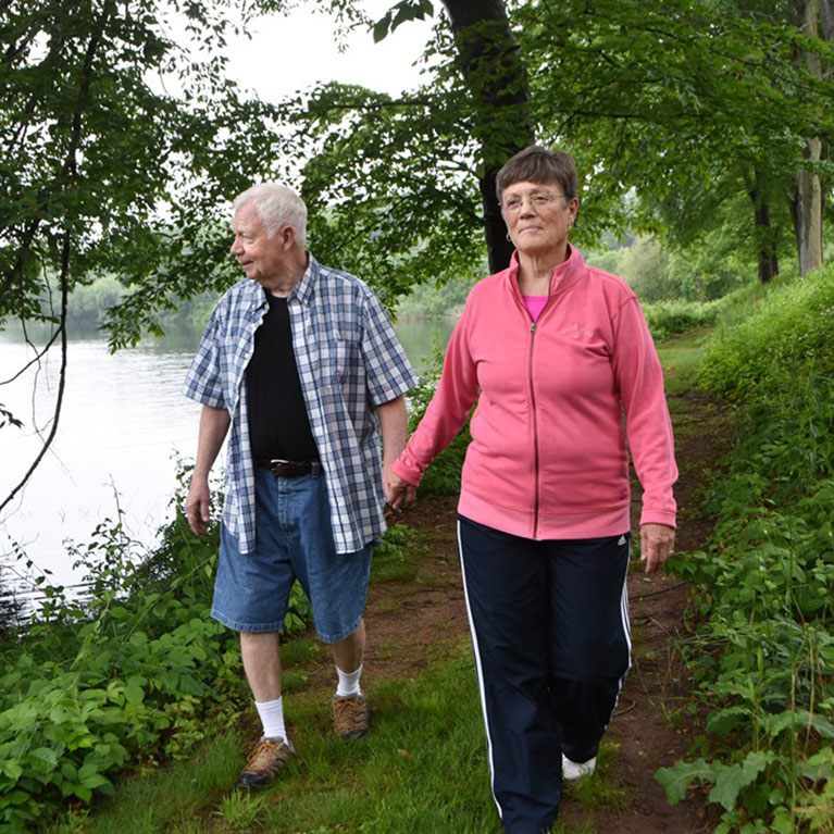Two Masonicare residents take a walk lakeside.