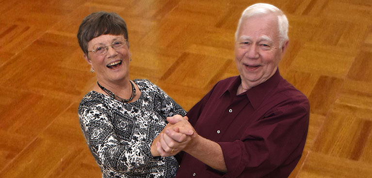 Two seniors enjoying dancing in on of Masonicare's fitness centers