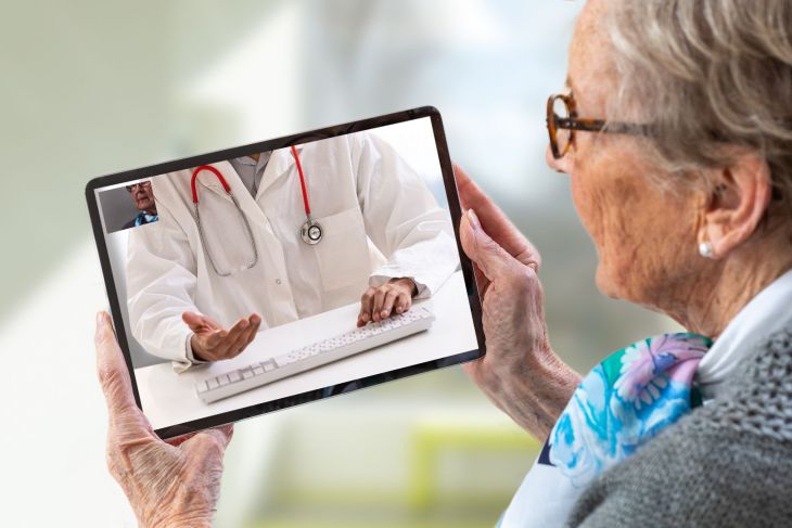 woman on ipad video call with doctor