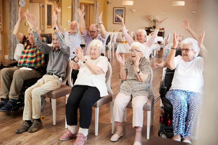 Seniors enjoying group chair exercises