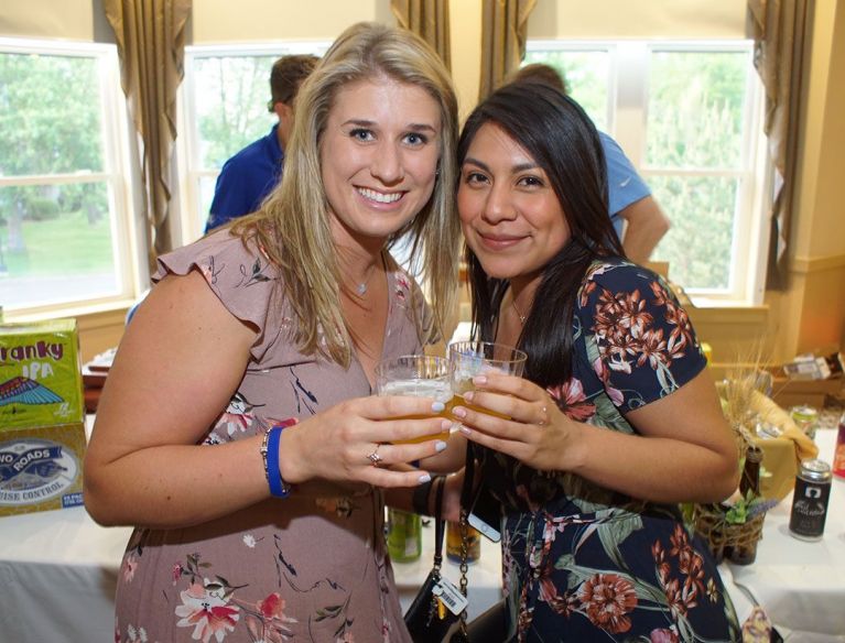 Two young girls enjoying drinks at Mosonicare Wine and Beer Tasting