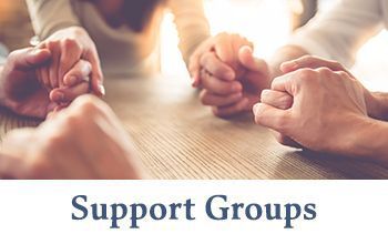 members holding hands at a support group