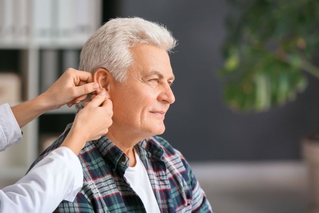 doctor_putting_in_hearing_aid.jpeg